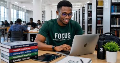 A focused university student researching online opportunities using a comprehensive student career and scholarship guide.
